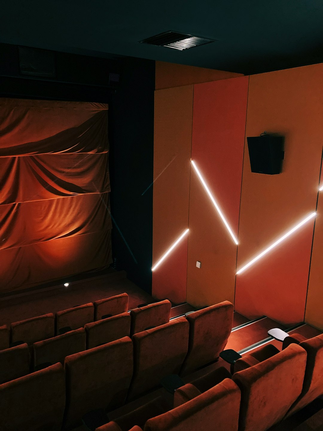 Cinema, movie theatre with chair and lighting on the wall.